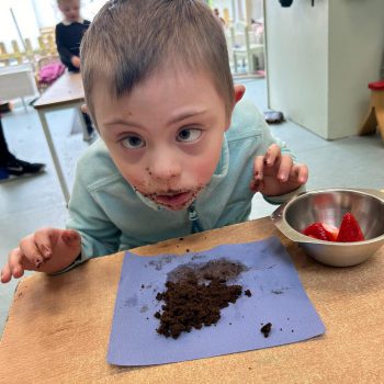 Child enjoying chocolate and Strawberries