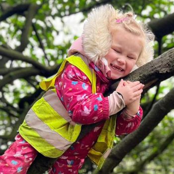 Child playing in tree